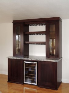 Mahogany adult beverage storage cabinets with LED illumination and granite counter top